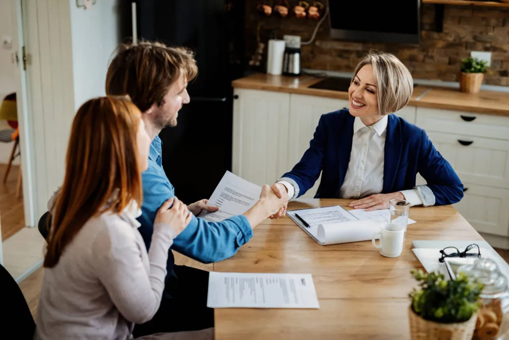 Housing professionals meeting with a couple