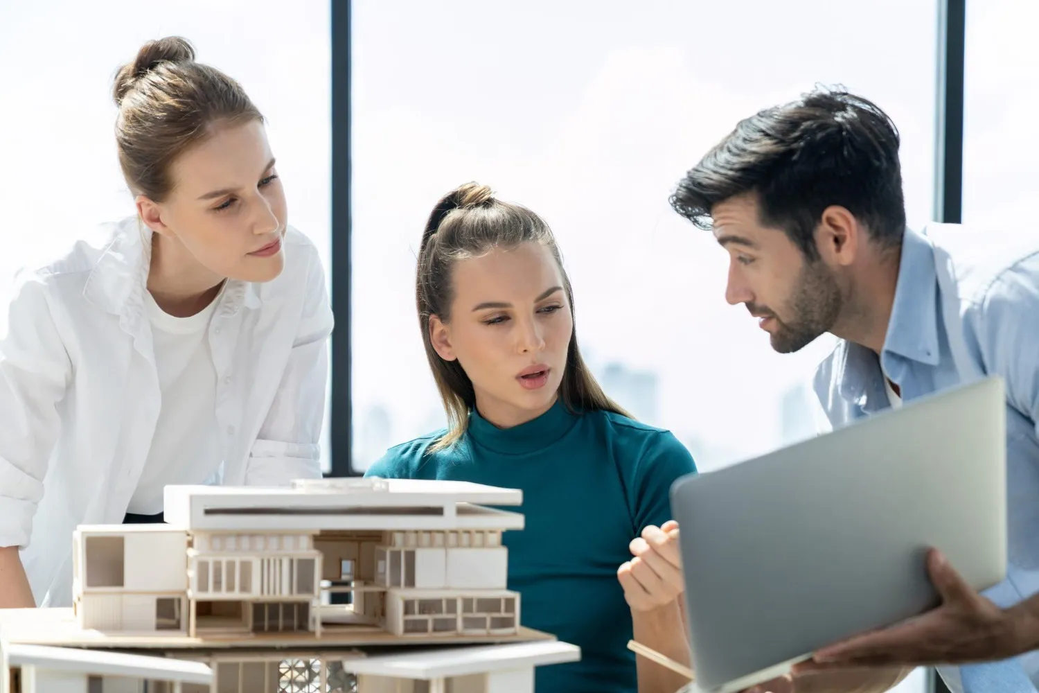 Property consultants reviewing an architectural housing model